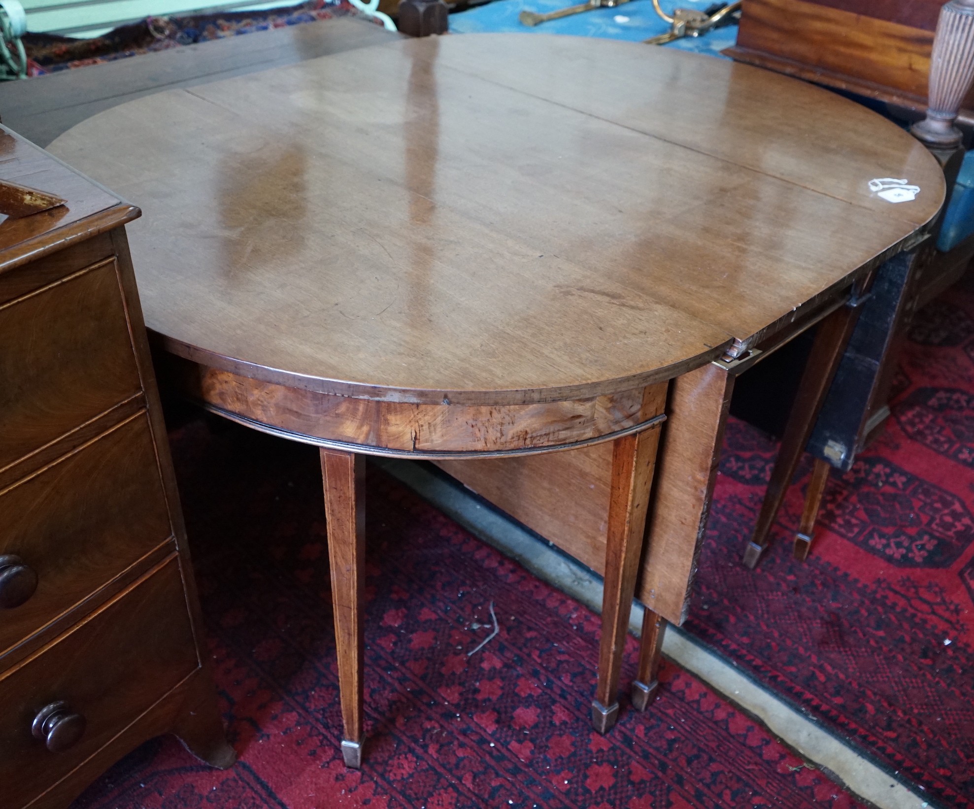 A George III mahogany D-end drop leaf extending dining table, 240cm extended, width 122cm, height 74cm